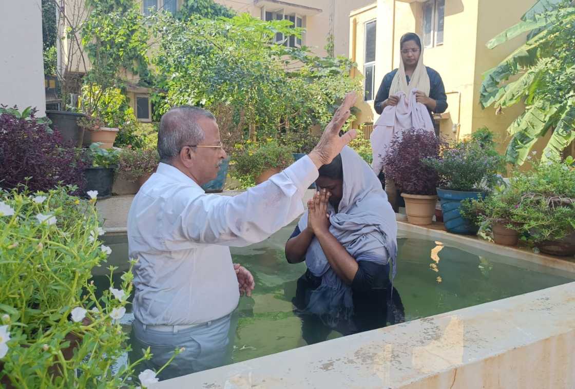 water baptism given by pastor to church believer