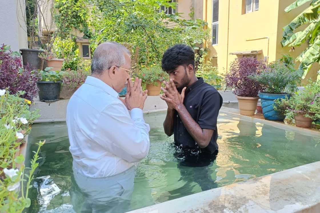 water baptism given by pastor to church believer