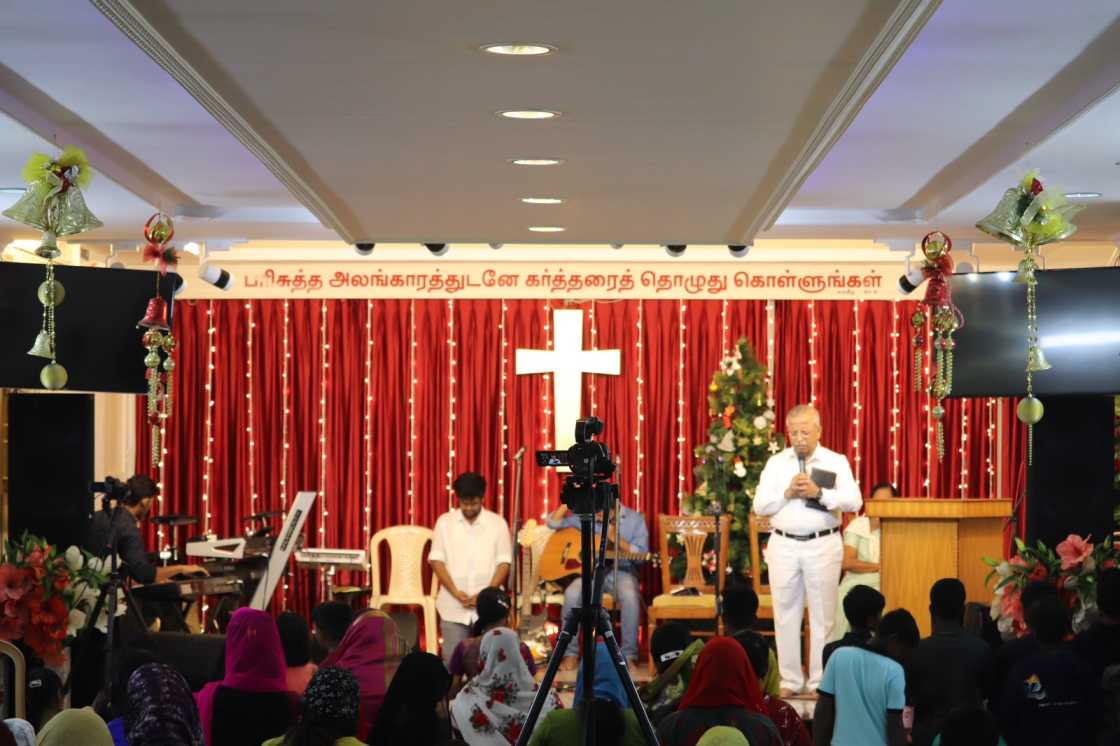 water baptism given by pastor to church believer